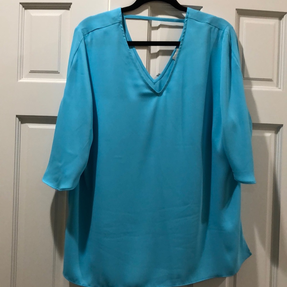 V-neck blouse in turquoise blue.